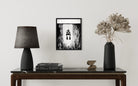 Black and white ink illustration in a frame of a diver ascending from underwater.